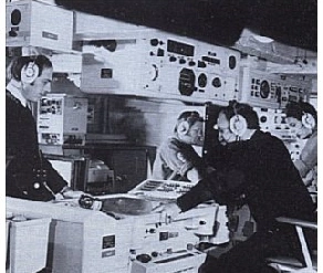 People operating vintage radio equipment