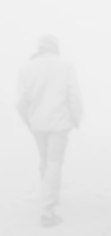 Figure disappearing into dense fog
